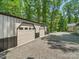 A spacious garage with multiple doors, ideal for storing vehicles and outdoor equipment at 2345 Stallings Rd, Matthews, NC 28104