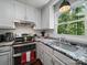 Bright kitchen with stainless steel appliances, granite countertops, and a view of the outdoors from the window at 2345 Stallings Rd, Matthews, NC 28104