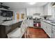 Kitchen view with white cabinets, stainless steel appliances, granite countertops, and wood flooring at 2345 Stallings Rd, Matthews, NC 28104