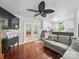 Open-concept living room and kitchen featuring hardwood floors, a ceiling fan, and a gray sofa at 2345 Stallings Rd, Matthews, NC 28104