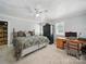 Bright main bedroom with a ceiling fan, a desk area, and two windows with views at 2345 Stallings Rd, Matthews, NC 28104