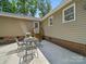 Back of house with patio and metal outdoor dining table and chairs at 2345 Stallings Rd, Matthews, NC 28104