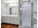 Bathroom featuring double sink vanity, a walk in shower, and hardwood floors at 2467 Hawk Ridge Dr, Gastonia, NC 28056