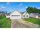 Well-maintained single-story home with an attached garage, green grass, and a concrete driveway at 2467 Hawk Ridge Dr, Gastonia, NC 28056