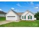 Charming single-story home with white siding, a manicured lawn, and an attached two-car garage at 2467 Hawk Ridge Dr, Gastonia, NC 28056