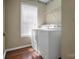 Laundry room with a washer, dryer, window and wire shelving unit at 2467 Hawk Ridge Dr, Gastonia, NC 28056