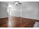 Bright, open living room featuring hardwood floors and neutral walls, leading to a dining area at 2467 Hawk Ridge Dr, Gastonia, NC 28056