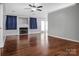 Bright living room with hardwood floors, a fireplace, and blue curtains at 2467 Hawk Ridge Dr, Gastonia, NC 28056