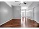 Open-concept living room with hardwood floors and neutral gray walls, offering a spacious feel at 2467 Hawk Ridge Dr, Gastonia, NC 28056