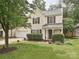 Charming two-story home featuring a well-manicured lawn, attached two-car garage, and inviting front porch at 2848 Huckleberry Hill Dr, Fort Mill, SC 29715