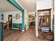 Bright foyer featuring a coat rack, vibrant accent wall, wood floors, and views into the living spaces at 2848 Huckleberry Hill Dr, Fort Mill, SC 29715
