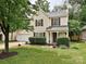 Inviting two-story home with a manicured lawn, charming front porch, and attached garage, offering curb appeal at 2848 Huckleberry Hill Dr, Fort Mill, SC 29715