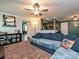 Inviting living room featuring a ceiling fan, plush sofa, and a view into the kitchen at 2848 Huckleberry Hill Dr, Fort Mill, SC 29715