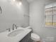 Bathroom with updated vanity, fixtures, and a window that provides natural light at 3133 Amay James Ave, Charlotte, NC 28208