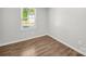 Bedroom features wood-look flooring and window with street views at 3133 Amay James Ave, Charlotte, NC 28208