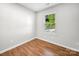 Bedroom with wood flooring and large window at 3133 Amay James Ave, Charlotte, NC 28208