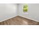 Bedroom offers wood-look flooring and a window providing natural light at 3133 Amay James Ave, Charlotte, NC 28208