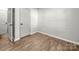 Bedroom features wood-look flooring, white trim, and an open doorway at 3133 Amay James Ave, Charlotte, NC 28208