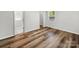 Bright bedroom features wood-look flooring, a closet, and a large window for natural light at 3133 Amay James Ave, Charlotte, NC 28208