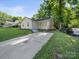 Well-maintained home with a long driveway and a green lawn at 3133 Amay James Ave, Charlotte, NC 28208