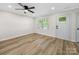 Bright living room features modern flooring, neutral walls, and ceiling fan for comfortable living at 3133 Amay James Ave, Charlotte, NC 28208