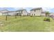 Large, grassy backyard with wood fence and adjacent home exteriors, perfect for outdoor activities and relaxation at 3304 Saddlebrook Dr, Midland, NC 28107