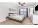 Bedroom with a wood frame bed, soft green linens and a ceiling fan at 3304 Saddlebrook Dr, Midland, NC 28107