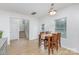 Inviting dining area with natural light, hardwood floors, a wooden dining table, and a view of the stairs at 3304 Saddlebrook Dr, Midland, NC 28107