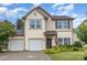 Charming two-story home with a well-maintained front yard, two-car garage, and welcoming front door at 3304 Saddlebrook Dr, Midland, NC 28107