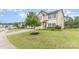 Well-manicured lawn with a young tree in the yard of a charming two-story home at 3304 Saddlebrook Dr, Midland, NC 28107