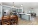 Modern kitchen open to the living room with stainless steel appliances, granite counters, and hardwood floors at 3304 Saddlebrook Dr, Midland, NC 28107