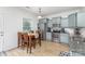 Bright kitchen with stainless steel appliances, granite countertops, and a dining table for casual meals at 3304 Saddlebrook Dr, Midland, NC 28107