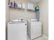 Bright laundry room featuring washer, dryer, storage shelf and ironing board at 3304 Saddlebrook Dr, Midland, NC 28107