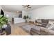 Open-concept living room with hardwood floors, stylish sectional sofa, and easy access to the kitchen at 3304 Saddlebrook Dr, Midland, NC 28107