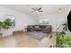 Bright living room featuring hardwood floors, a comfortable sectional sofa, and large windows at 3304 Saddlebrook Dr, Midland, NC 28107
