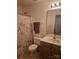 Compact bathroom with vanity, toilet, and shower, complemented by a Paris-themed shower curtain at 3944 Town Center Rd, Harrisburg, NC 28075