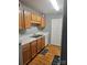 Practical kitchen featuring wood cabinets, white countertops and appliances offering efficiency and storage at 3944 Town Center Rd, Harrisburg, NC 28075