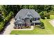 Stunning aerial view of a two-story home featuring lush landscaping, and a beautiful gray roof at 3963 Harmattan Dr, Denver, NC 28037