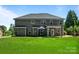 Expansive backyard with a well-manicured lawn, patio, and house's exterior at 3963 Harmattan Dr, Denver, NC 28037