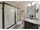 Bathroom with framed glass shower door, granite countertop, and decorative light fixture at 3963 Harmattan Dr, Denver, NC 28037