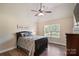 Well-lit bedroom features a window view, vaulted ceilings, and dark wood accents at 3963 Harmattan Dr, Denver, NC 28037