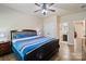 Comfortable bedroom featuring hardwood floors, ceiling fan, and adjacent bathroom for easy access at 3963 Harmattan Dr, Denver, NC 28037