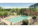Outdoor community pool surrounded by lounge chairs and trees at 3963 Harmattan Dr, Denver, NC 28037