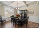 Formal dining room with coffered ceilings, wainscoting, hardwood floors, and elegant chandelier at 3963 Harmattan Dr, Denver, NC 28037