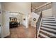 Welcoming foyer with hardwood floors, staircase with rod iron spindles, and an archway leading to the dining room at 3963 Harmattan Dr, Denver, NC 28037