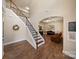 Elegant foyer featuring hardwood floors, a staircase with iron railings, and an arched entrance to the living room at 3963 Harmattan Dr, Denver, NC 28037
