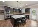Kitchen showcasing dark cabinetry, stainless steel appliances, granite counters and an island with seating at 3963 Harmattan Dr, Denver, NC 28037