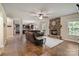 Inviting living room featuring a stone fireplace, ceiling fan, and hardwood floors at 3963 Harmattan Dr, Denver, NC 28037