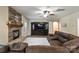 Comfortable living room with a stone fireplace, hardwood floors, and a large entertainment center at 3963 Harmattan Dr, Denver, NC 28037