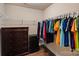 Organized walk-in closet with shelves, clothing rods, dresser, and mini refrigerator at 3963 Harmattan Dr, Denver, NC 28037
